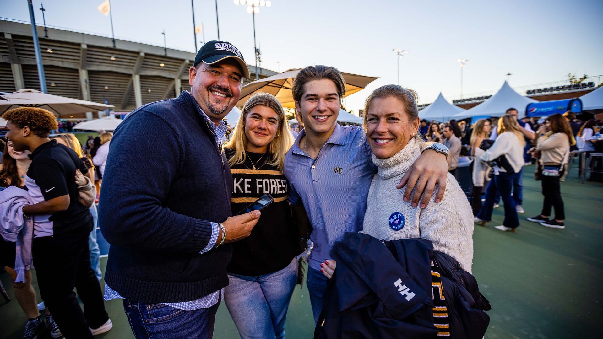 Photo of a family of four smiling for the camera at Student Tailgate at Wake Forest football